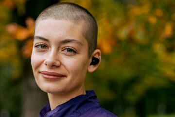 smiling woman in purple hoodie