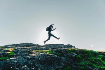 person on mid air above rocky hill, term life insurance